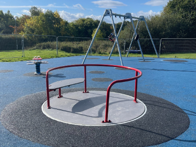 Image of a wheelchair accessible roundabout in children's play area.